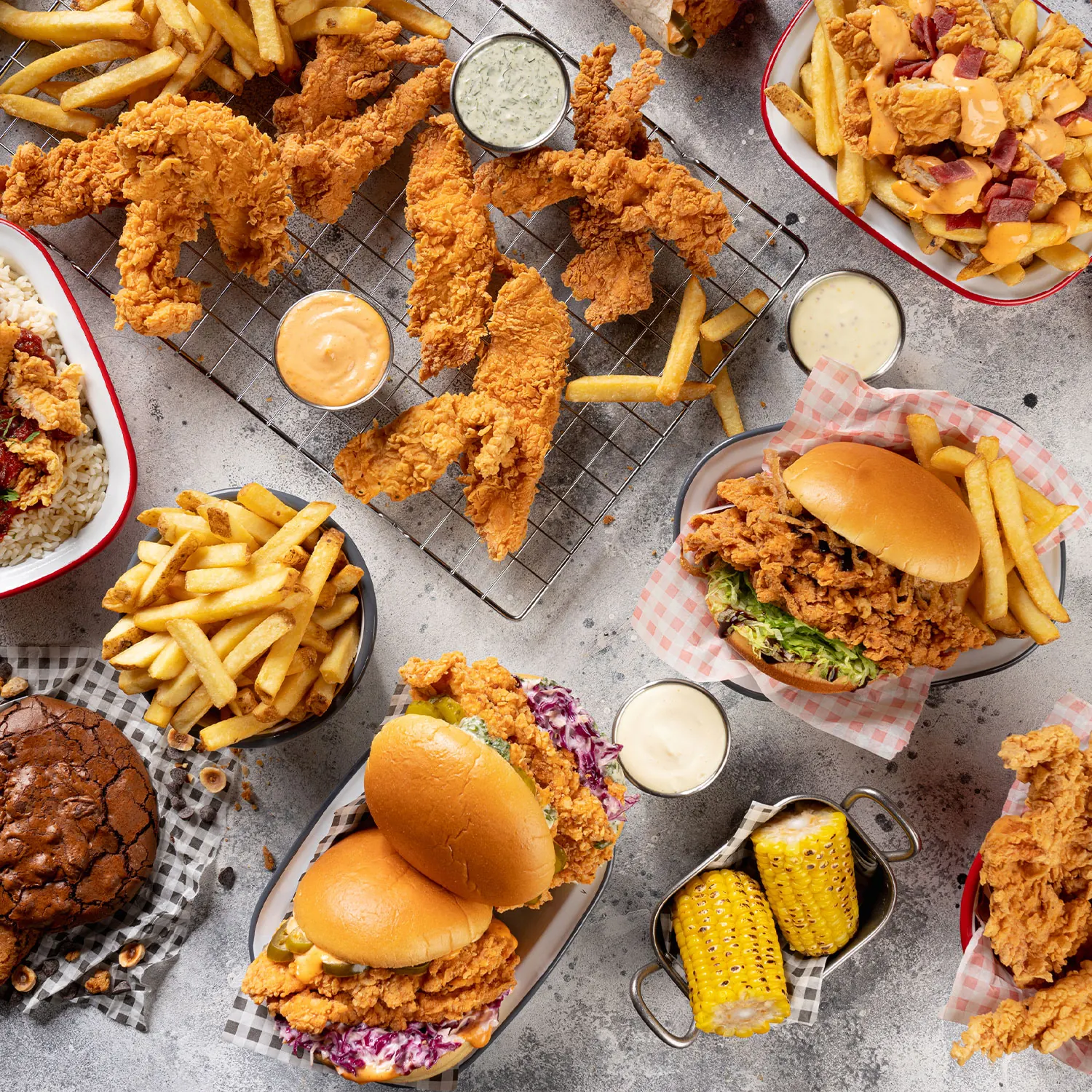 A table of fried chicken, burgers, fries and sides from FWB kitchens