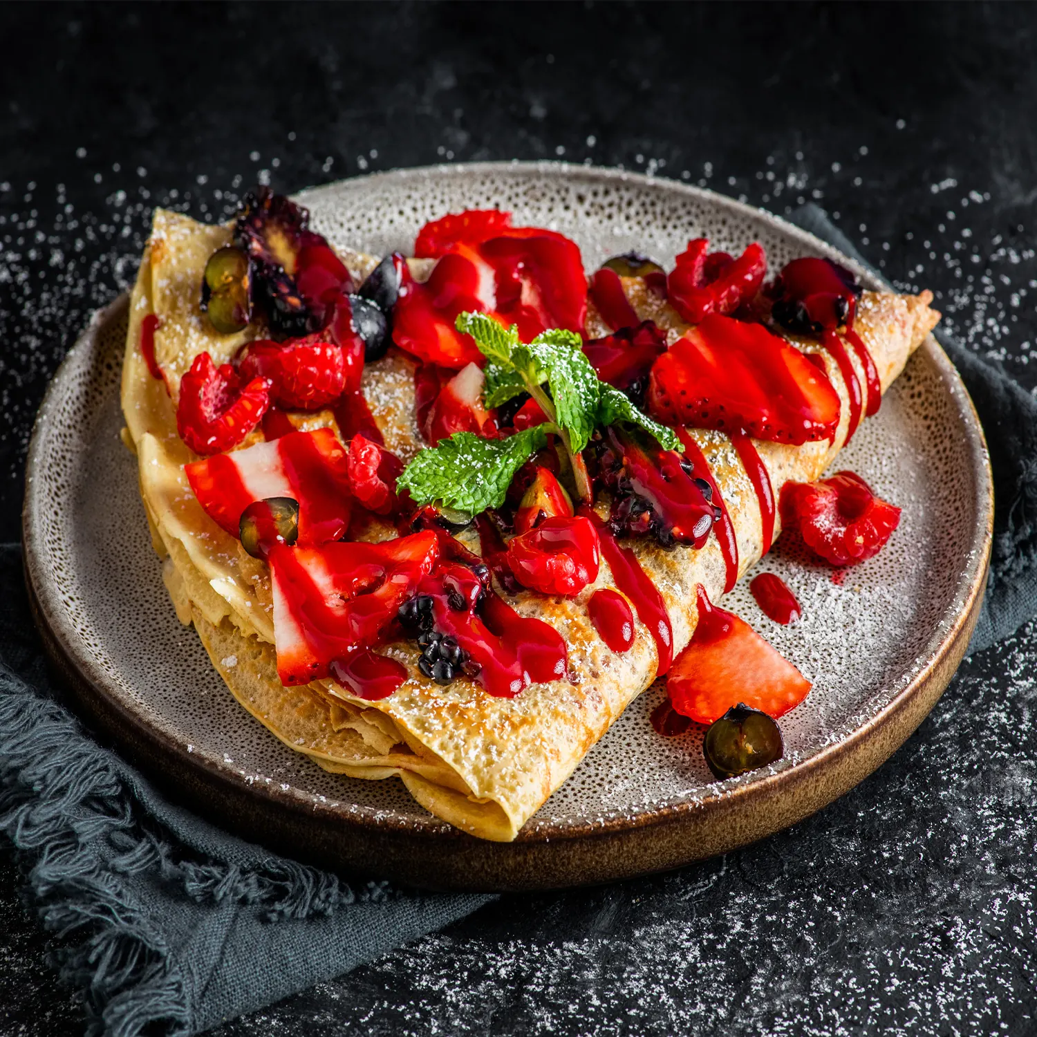Sweet Inc. crepe with berries and coulis