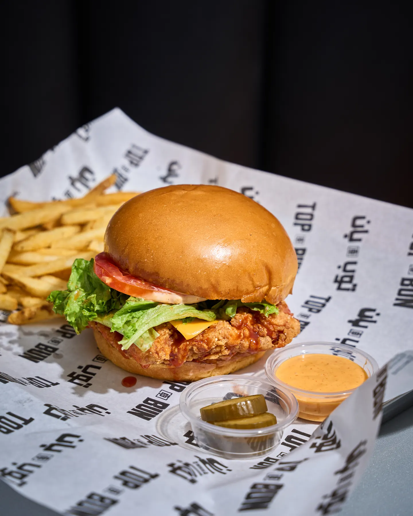 Top Bun crispy chicken burger with fries and house sauce